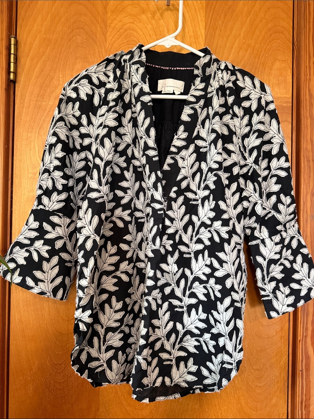 Anthropologie Black Blouse with White Leaf Stitching.